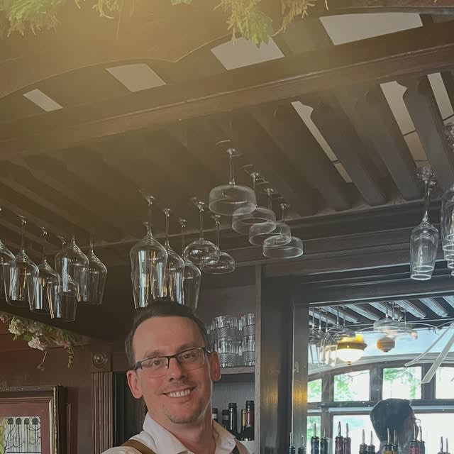 A bartender presenting a boot of beer for NeoVista's State Street birthday crawl